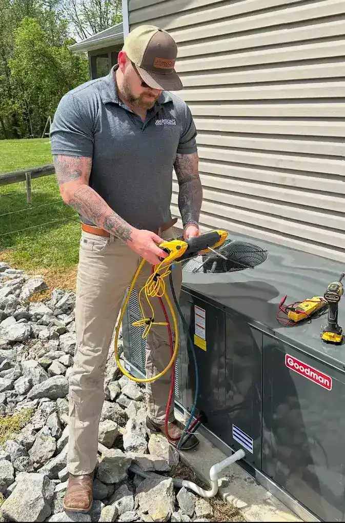 Johnson's HVAC Technician Working on AC Unit